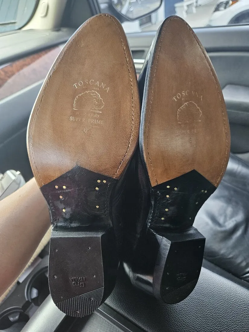 Both cowboy boots with new leather soles and new heels after the repair