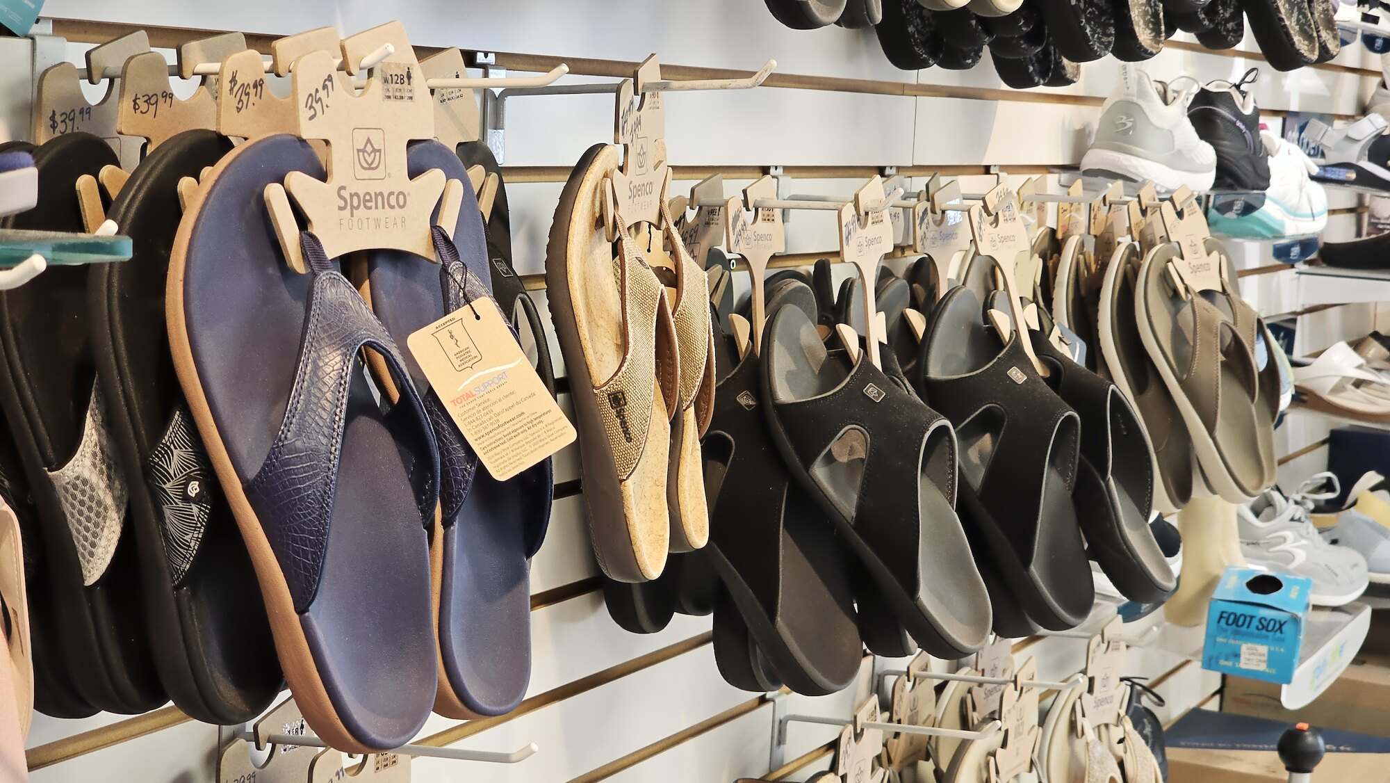 Wall of supportive sandals and comfort shoes in the shop