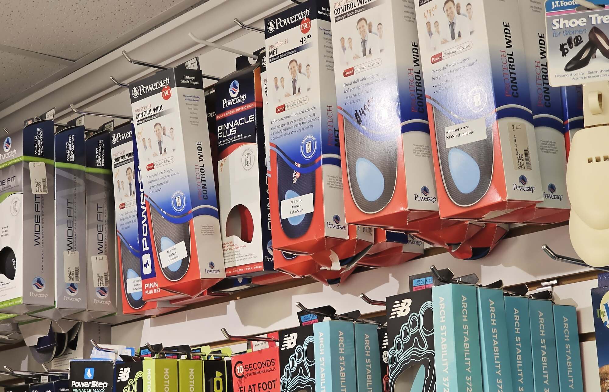 Wall of full-length orthotic insoles in the shop