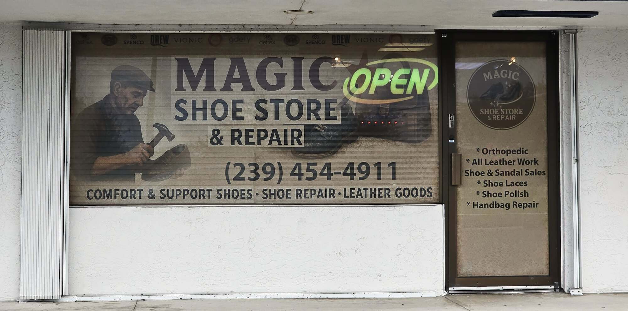 The Magic Shoe Store & Repair storefront window with the OPEN sign lit